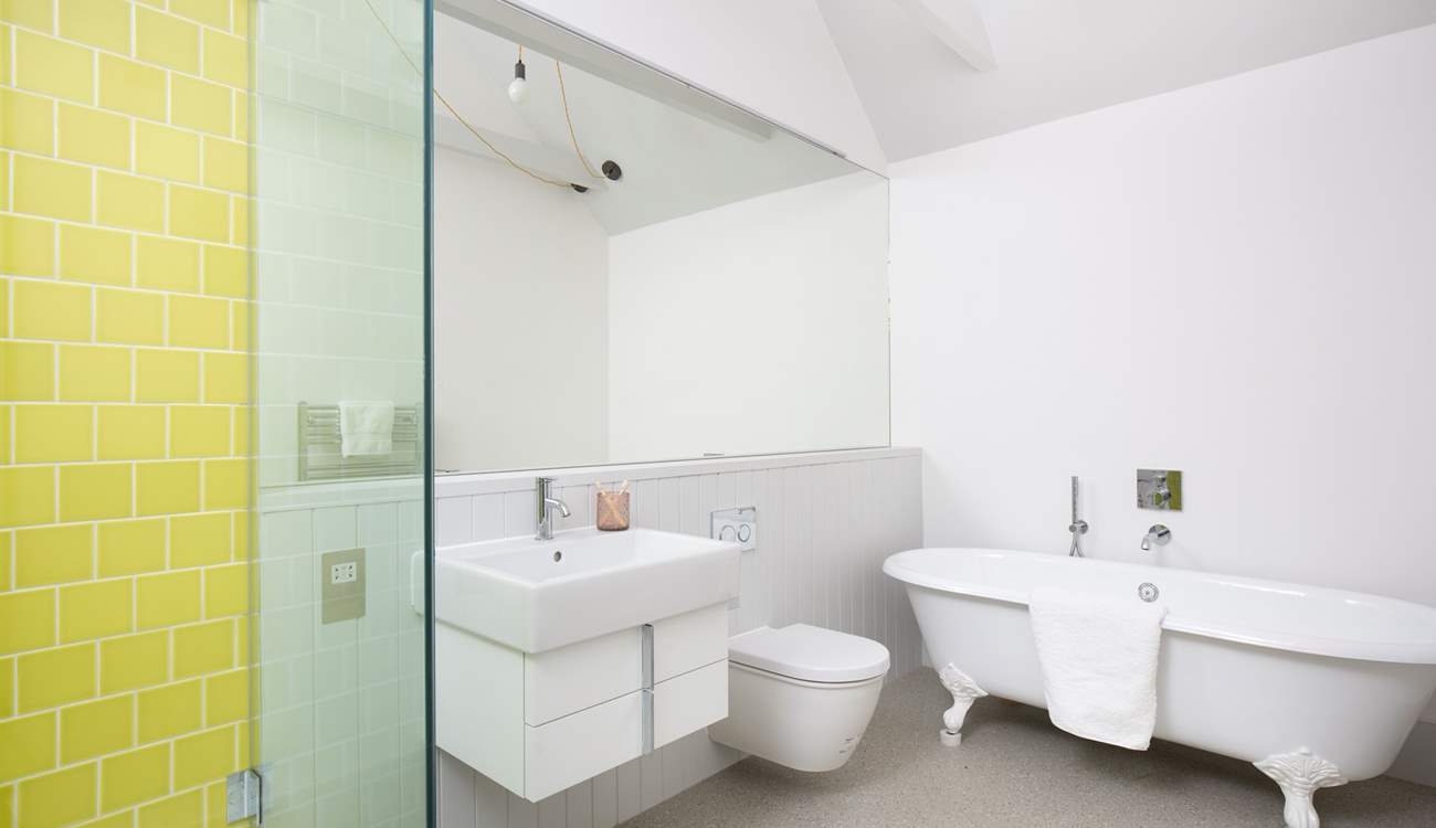 The en suite bathroom has a free-standing bath and shower.