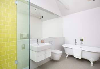 The en suite bathroom has a free-standing bath and walk-in shower.
