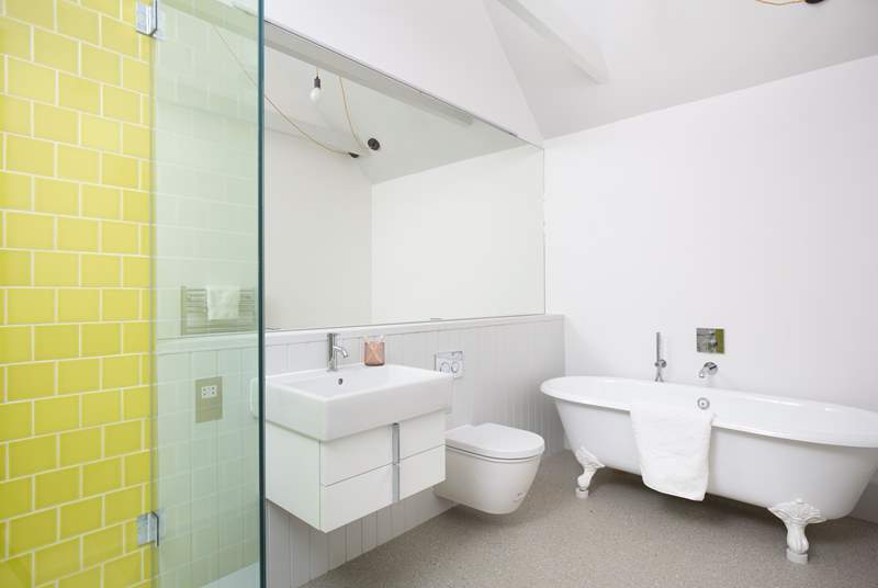 The en suite bathroom has a free-standing bath and walk-in shower.