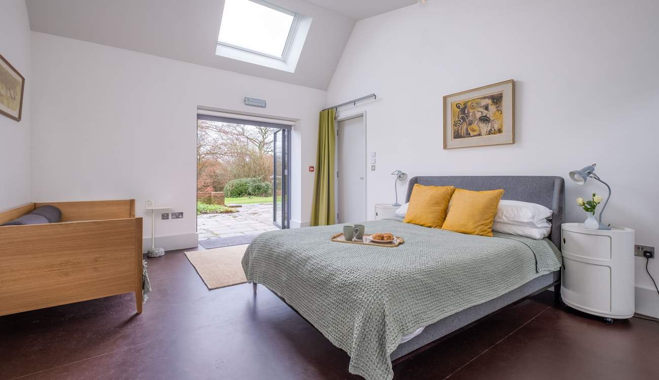 This family bedroom has double doors that open onto the terrace and garden.