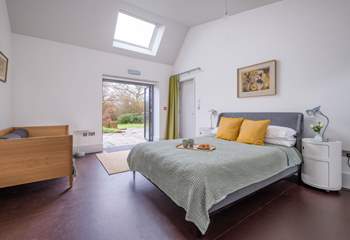 The family bedroom in South Barn has double doors that open onto the terrace and garden.
