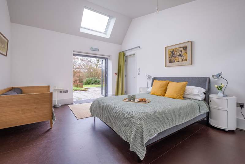The family bedroom in South Barn has double doors that open onto the terrace and garden.