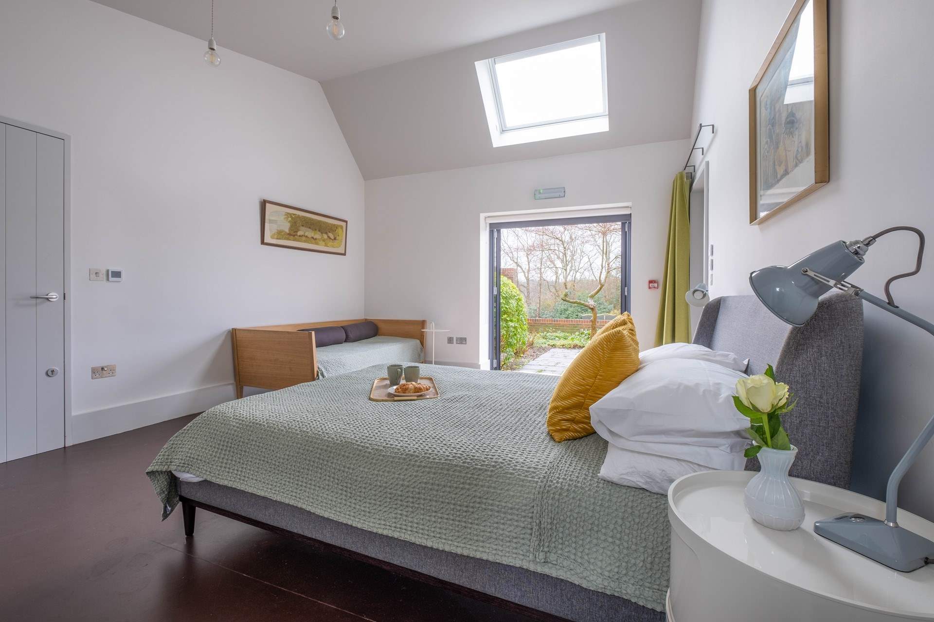 In the South Barn there is another lovely family room with king-size bed, single bed and doors that lead to the terrace and garden.