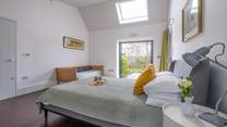 In the South Barn there is another lovely family room with king-size bed, single bed and doors that lead to the terrace and garden.