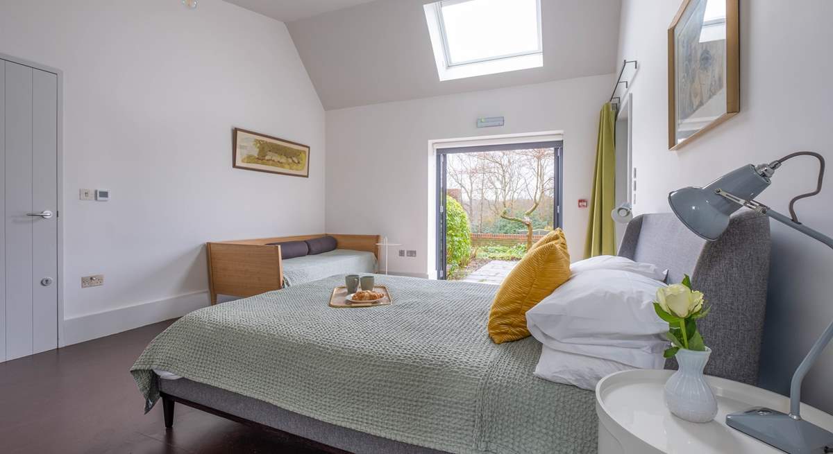 In the South Barn there is another lovely family room with king-size bed, single bed and doors that lead to the terrace and garden.