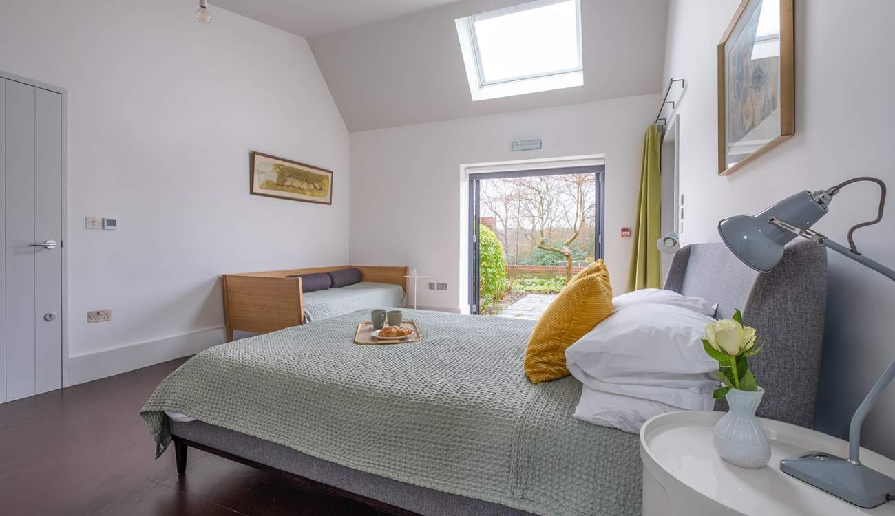 In the South Barn there is another lovely family room with king-size bed, single bed and doors that lead to the terrace and garden.