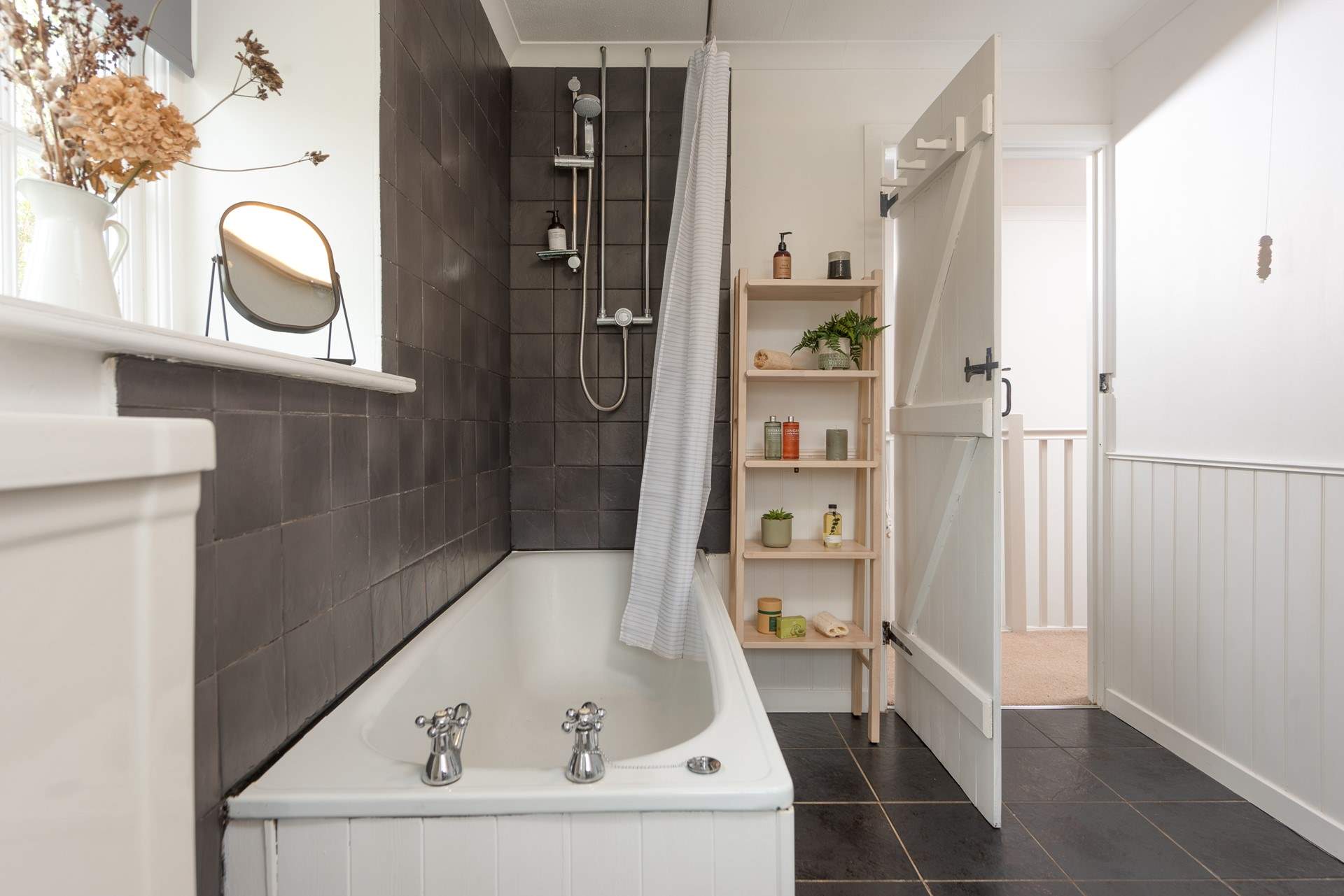The family bathroom located on the first floor has a bath with shower over.