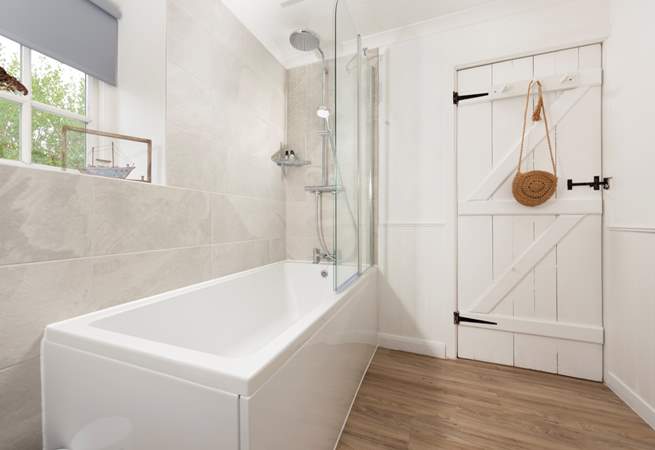 The family bathroom located on the first floor has a bath with shower over.