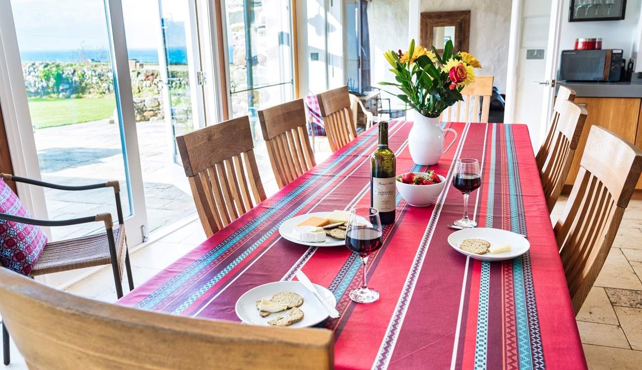 Plenty of room for everyone around the table... glance out at the blue sea.