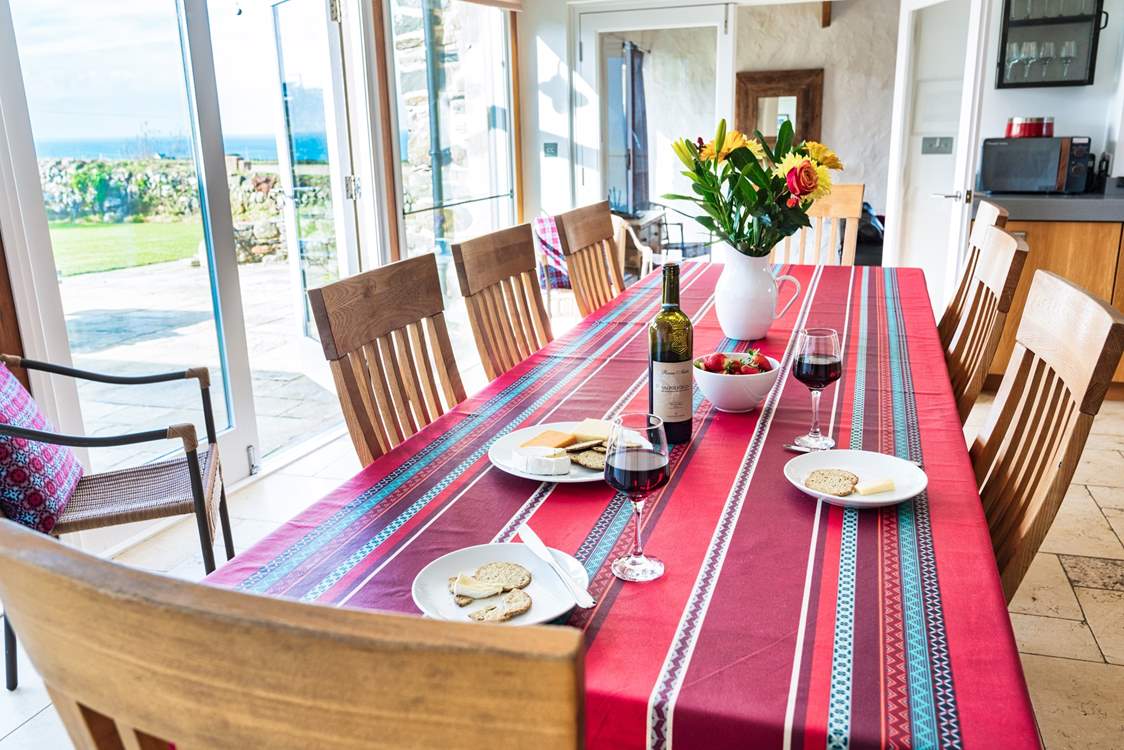 Plenty of room for everyone around the table... glance out at the blue sea.