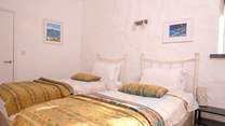 Bedroom 3, a cosy twin room with stylish Welsh furnishings. 