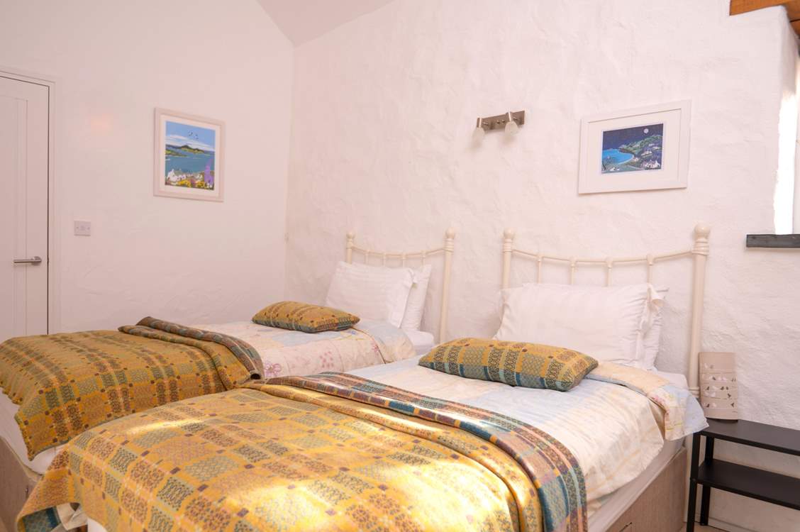 Bedroom 3, a cosy twin room with stylish Welsh furnishings.