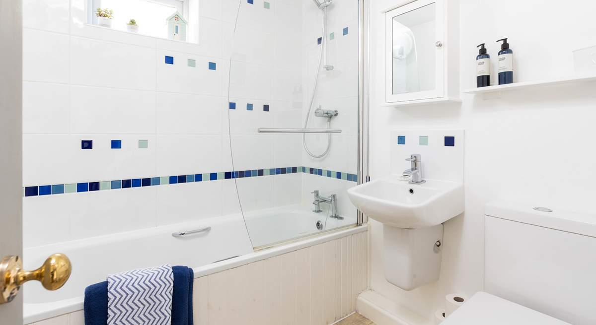 The family bathroom has a bath with shower over.