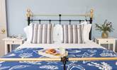 The double bedroom has a lovely iron bedstead and pretty linens. - Thumbnail Image