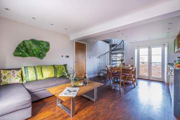 The open plan living area has everything close to hand. There is no television in the living area but you can plug your devices into the internet or watch television upstairs in the mezzanine snug.