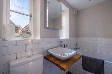 There is a downstairs bathroom which has a bath and shower attachment.