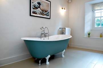 The family bathroom is accessed up a few steps and has a gorgeous free-standing bath, inviting you to chill out and enjoy a long leisurely soak.