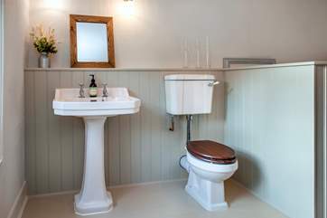 The styling in the bathroom perfectly complements the age of the house.