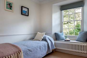 The single bedroom sits at the front of the house overlooking the garden.