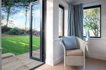 Double doors from the garden-room/bedroom 5 lead out to the garden at the back, with views over the village and out to sea.