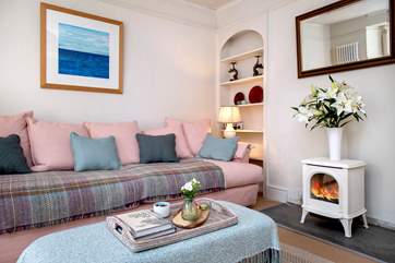 The elegant sitting-room has an electric flame stove, which gives the effect of a wood-burning stove, without all the hassle.