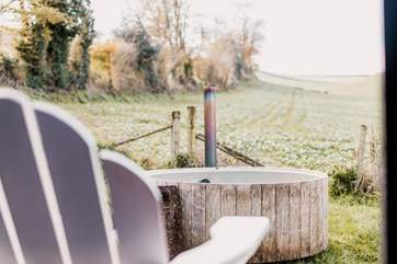 The steamy wood-fired hot tub is just a few steps away from the main bedroom.