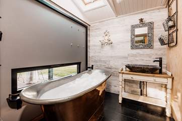 The separate bathroom is beyond gorgeous, just look at that dreamy bath tub!