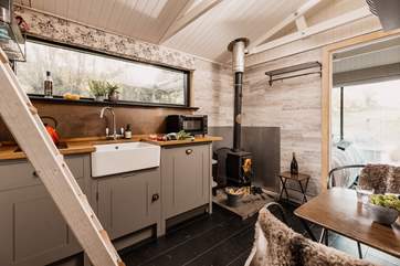 The cosy kitchen is warm and welcoming, with a beautiful wood-burner to keep you extra toasty.