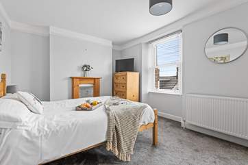 Bedroom 1 has a comfy king-size bed and additional bunk-beds, ideal for larger family groups.