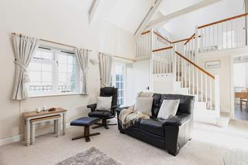 The separate kitchen leads off the sitting/dining-room with the bedroom on the mezzanine level.