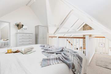 The gorgeous bedroom is decorated in relaxing pastel shades.