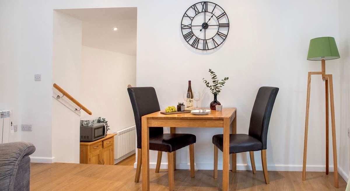 Steps lead down from the sitting/dining area to the charming kitchen.