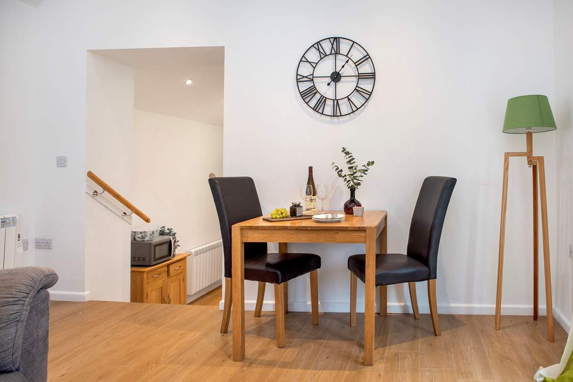 Steps lead down from the sitting/dining area to the charming kitchen.
