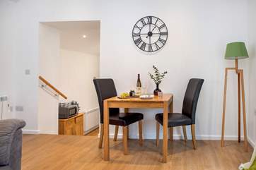 Steps lead down from the sitting/dining area to the charming kitchen.