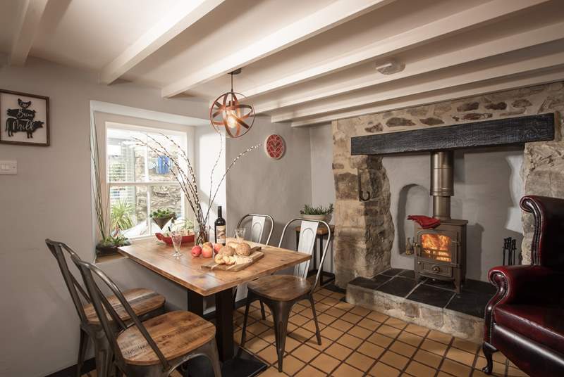 The kitchen/diner has a fabulous feature fireplace with toasty wood-burner.
