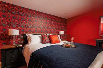 The sumptuous king-size bed, adorned with luxurious soft linen.