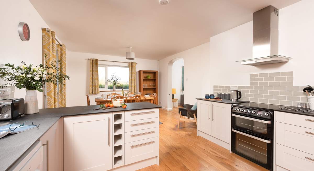 From the dining area, the archway leads through to the sitting-room.