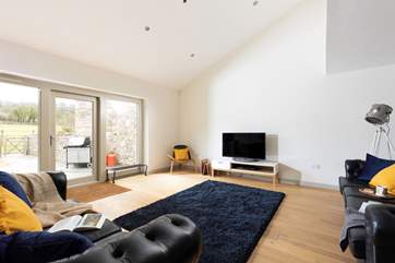 The open plan living-room includes a comfy sitting-area to enjoy.