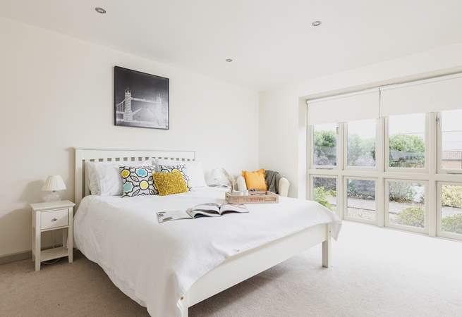 On the ground floor, this bedroom has an en suite and a walk-in wardrobe.