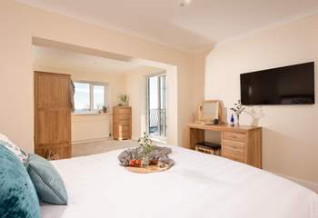 Bedroom one is a wonderfully spacious room with fabulous sea views and access to the first floor balcony.