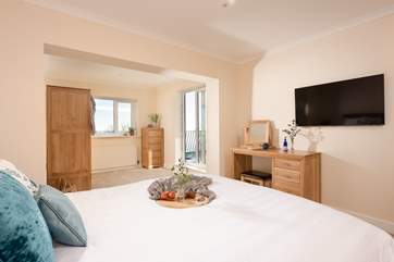 Bedroom one is a wonderfully spacious room with fabulous sea views and access to the first floor balcony.