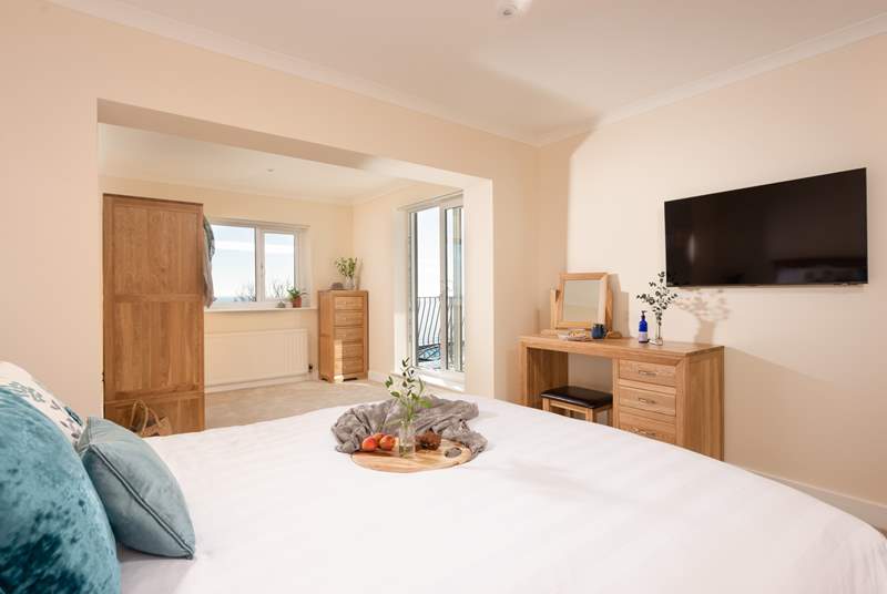 Bedroom one is a wonderfully spacious room with fabulous sea views and access to the first floor balcony.
