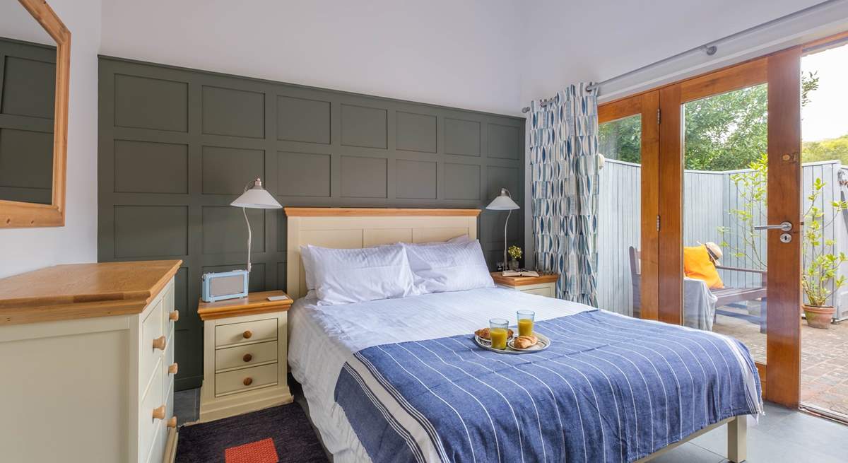 The double bedroom with double doors leading to the courtyard garden.