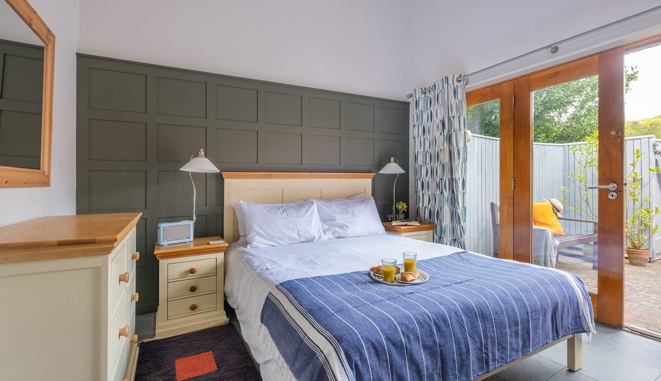 The double bedroom with double doors leading to the courtyard garden.