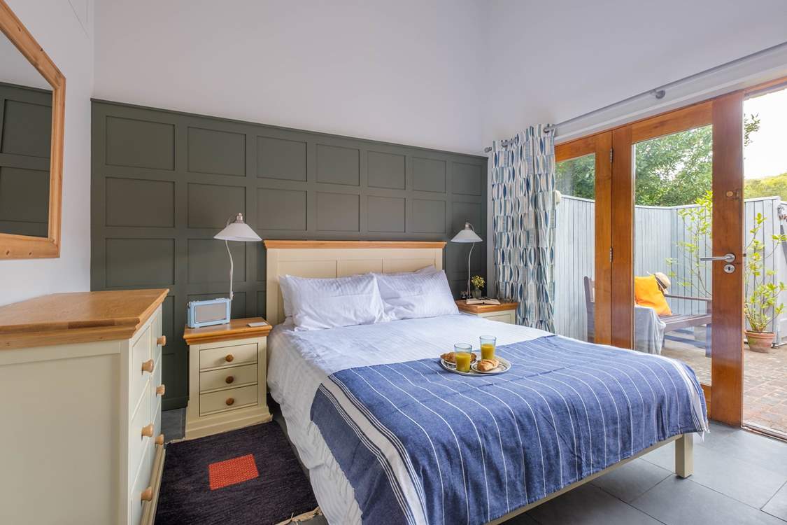 The double bedroom with double doors leading to the courtyard garden.