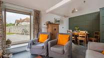 The sitting/dining-room is light and airy.