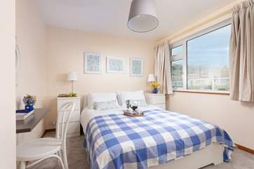 The pretty main bedroom has a comfy king-size double bed for a restful night.
