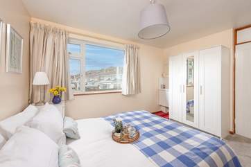 The pretty main bedroom has a comfy king-size bed.