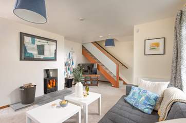 Stairs lead to the first floor from the stylish sitting-room.