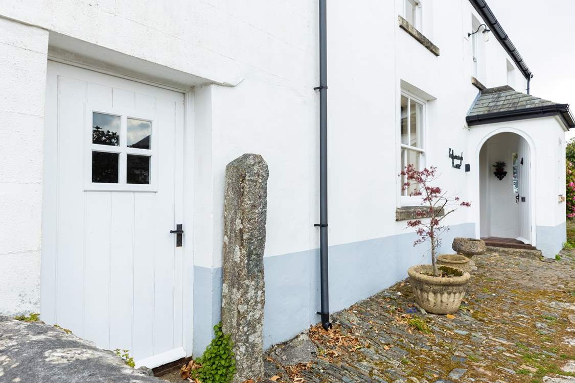 The front door leads into the ground floor living space.
Please note the bike storage-room with tumble-drier is on the left of this picture.
